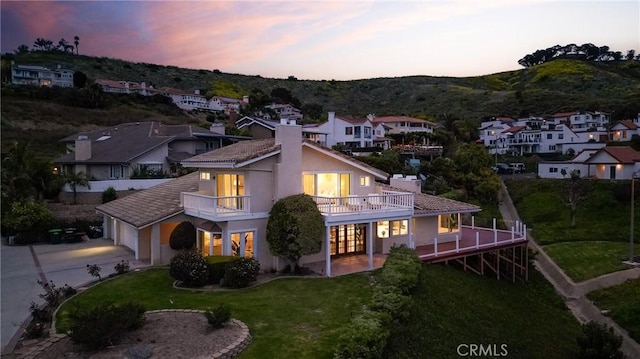 3823 Via Manzana, San Clemente, CA 92673 - back of property with a chimney, a yard, stucco siding, a balcony, and driveway