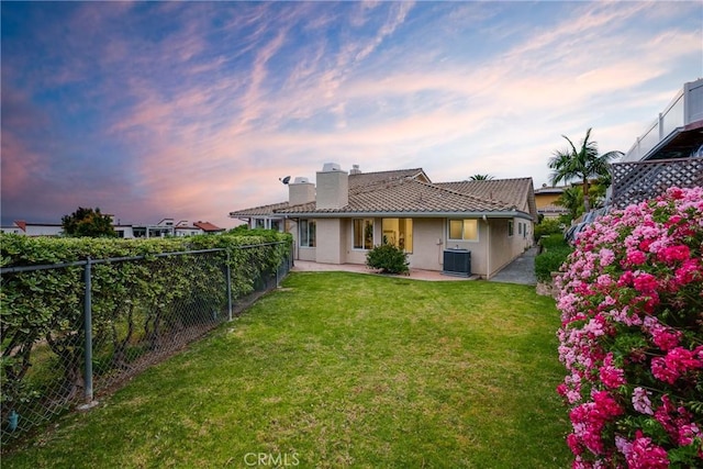 3823 Via Manzana, San Clemente, CA 92673 - back of property at dusk featuring a chimney, a fenced backyard, stucco siding, a patio, and a tile roof