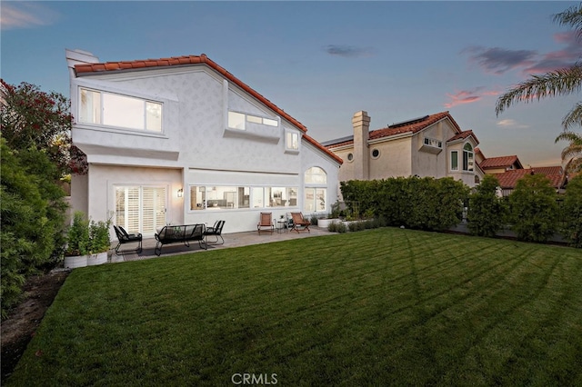 10 Novilla, Laguna Niguel, CA 92677 - back of house featuring a patio area, stucco siding, a yard, and a tile roof