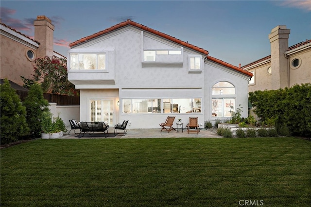 10 Novilla, Laguna Niguel, CA 92677 - rear view of property featuring a patio area, a yard, stucco siding, and a tiled roof