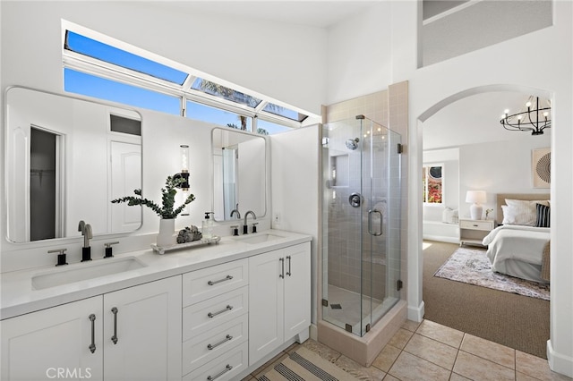10 Novilla, Laguna Niguel, CA 92677 - ensuite bathroom featuring double vanity, a chandelier, a shower stall, tile patterned flooring, and a high ceiling