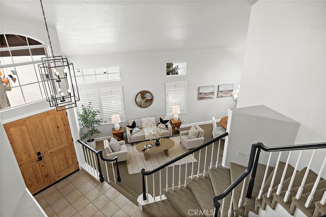 10 Novilla, Laguna Niguel, CA 92677 - tiled living area with healthy amount of natural light, stairs, and a chandelier