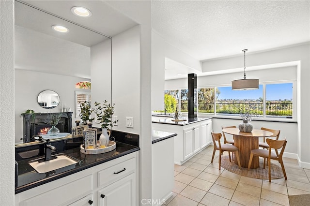10 Novilla, Laguna Niguel, CA 92677 - bar featuring light tile patterned flooring, a lit fireplace, hanging light fixtures, recessed lighting, and a textured ceiling