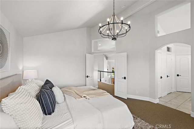 10 Novilla, Laguna Niguel, CA 92677 - bedroom featuring carpet floors, arched walkways, a chandelier, and high vaulted ceiling
