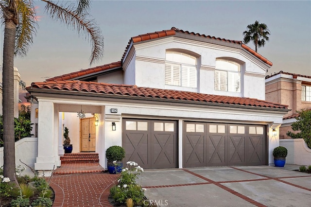 10 Novilla, Laguna Niguel, CA 92677 - mediterranean / spanish house featuring driveway, a garage, a tile roof, and stucco siding