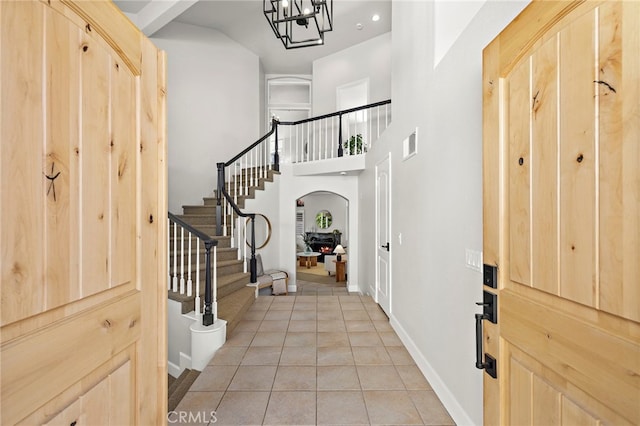 10 Novilla, Laguna Niguel, CA 92677 - entryway featuring arched walkways, light tile patterned floors, stairs, a chandelier, and recessed lighting