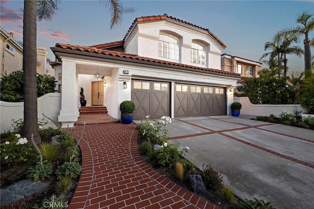 10 Novilla, Laguna Niguel, CA 92677 - mediterranean / spanish-style house featuring driveway, stucco siding, a garage, and a tiled roof