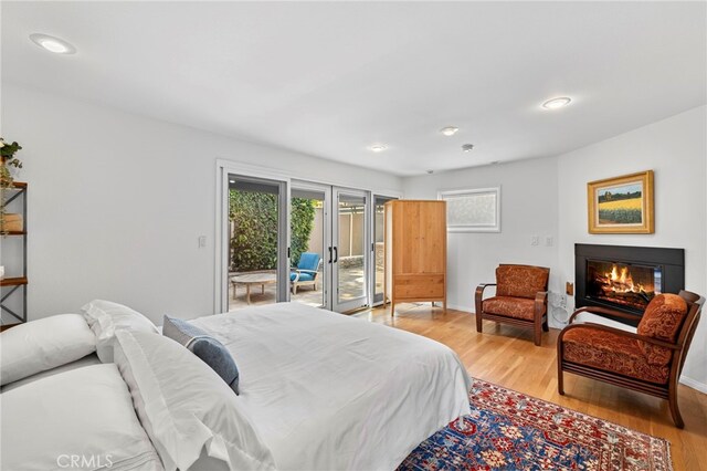 430 Anita St, Laguna Beach, CA 92651 - bedroom featuring access to exterior, light wood finished floors, a glass covered fireplace, and recessed lighting
