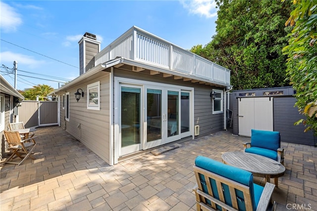 430 Anita St, Laguna Beach, CA 92651 - rear view of property featuring a patio, a chimney, a balcony, and a gate