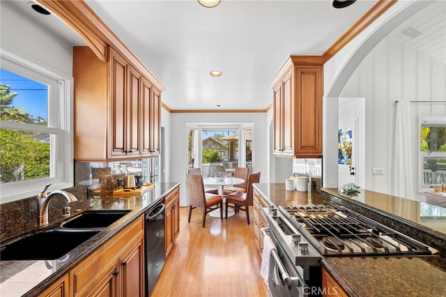 430 Anita St, Laguna Beach, CA 92651 - kitchen featuring dishwasher, gas stove, light wood finished floors, dark stone countertops, and brown cabinetry