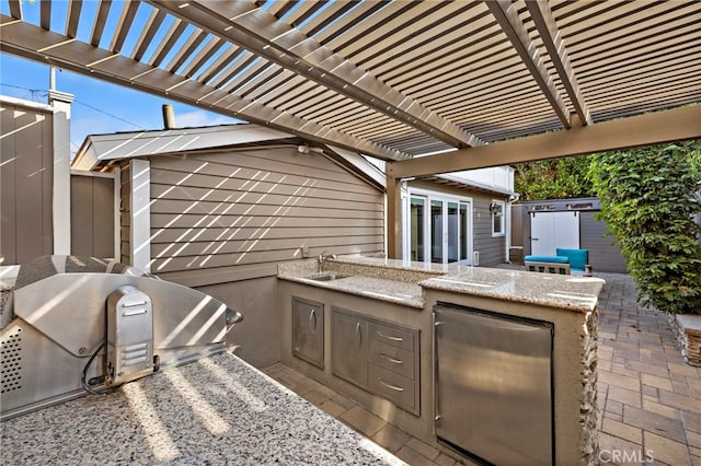 430 Anita St, Laguna Beach, CA 92651 - view of patio / terrace featuring exterior kitchen, a pergola, and a storage shed