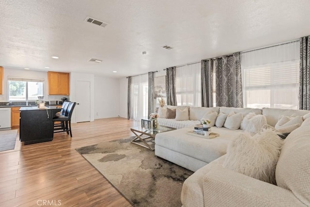 14075 Tourmaline St, Hesperia, CA 92344 - living room with light wood-type flooring and recessed lighting