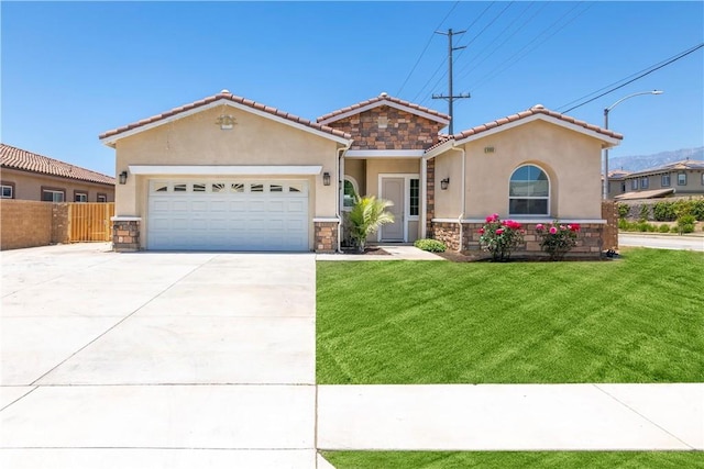 6908 Oleander Ave, Fontana, CA 92336 - view of front of house featuring stone siding, stucco siding, driveway, and an attached garage