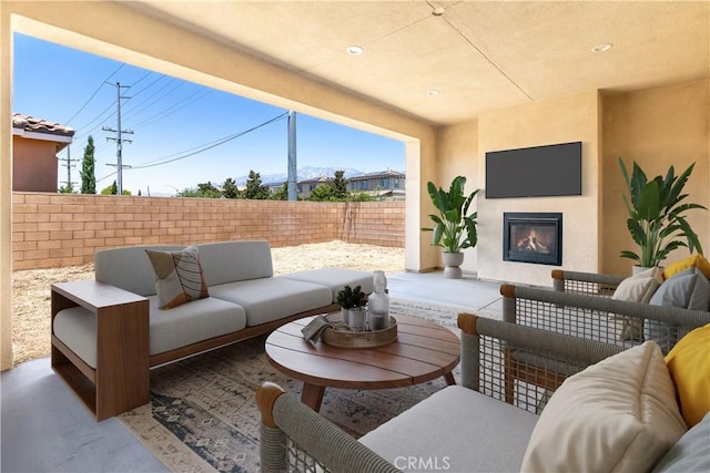 6908 Oleander Ave, Fontana, CA 92336 - fenced backyard featuring an outdoor living space with a fireplace and a patio area
