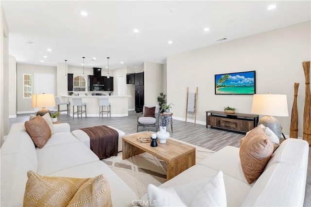6908 Oleander Ave, Fontana, CA 92336 - living area with recessed lighting and light wood-style flooring