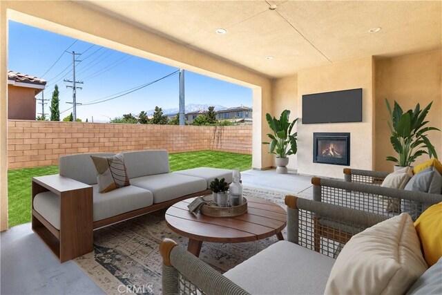 6908 Oleander Ave, Fontana, CA 92336 - fenced backyard with an outdoor living space with a fireplace and a patio area
