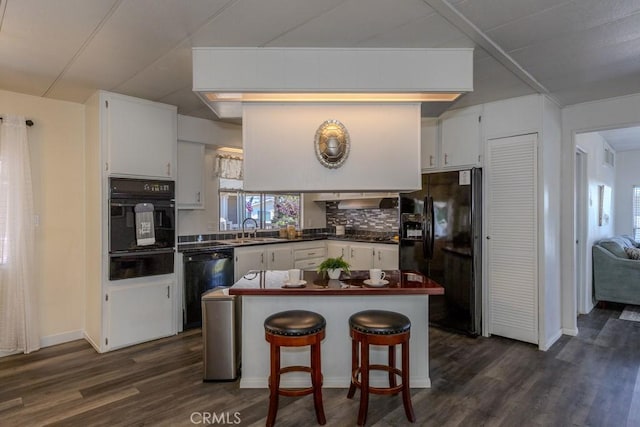 2851 Rolling Hills Dr Unit 255, Fullerton, CA 92835 - kitchen featuring black appliances, a warming drawer, dark wood-style floors, dark countertops, and white cabinetry