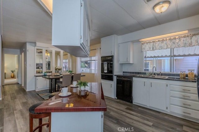 2851 Rolling Hills Dr Unit 255, Fullerton, CA 92835 - kitchen featuring black appliances, white cabinetry, and dark countertops