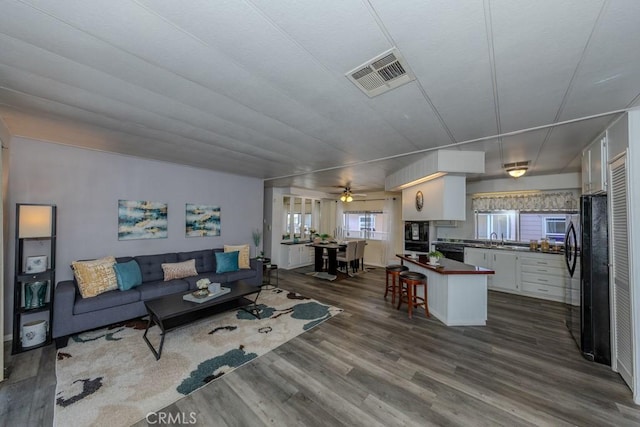 2851 Rolling Hills Dr Unit 255, Fullerton, CA 92835 - living area with dark wood-type flooring and ceiling fan