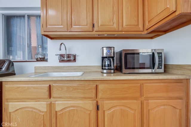 2741 S Walker Ave, San Pedro, CA 90731 - kitchen with stainless steel microwave, light countertops, light brown cabinetry, and range