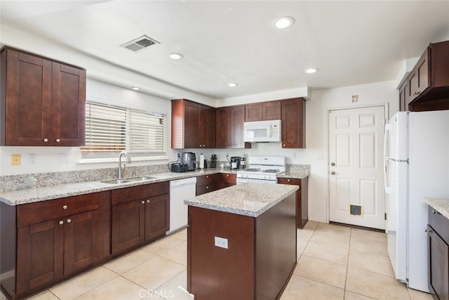 31652 Loma Linda Rd, Temecula, CA 92592 - kitchen with white appliances, light tile patterned floors, a center island, light stone countertops, and recessed lighting
