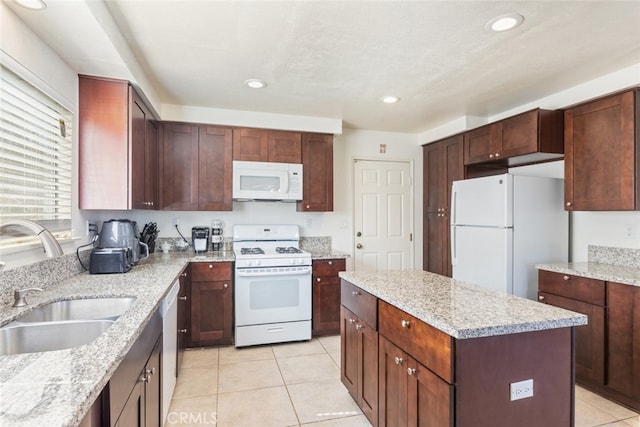 31652 Loma Linda Rd, Temecula, CA 92592 - kitchen with white appliances, light tile patterned flooring, a center island, light stone counters, and recessed lighting