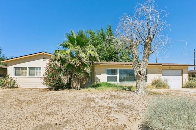 15917 Lee St, Mojave, CA 93501 - view of front of house featuring an attached garage, stucco siding, and concrete driveway