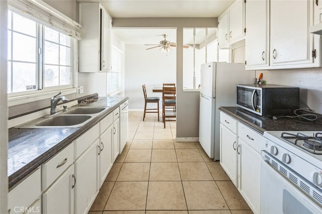 15917 Lee St, Mojave, CA 93501 - kitchen featuring white appliances, white cabinetry, dark countertops, and a ceiling fan