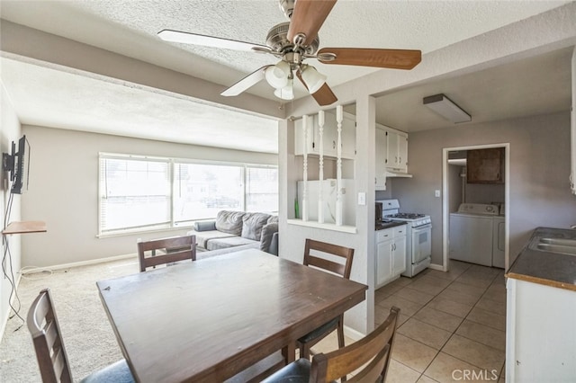 15917 Lee St, Mojave, CA 93501 - dining space featuring ceiling fan, washer and dryer, light tile patterned floors, and a textured ceiling