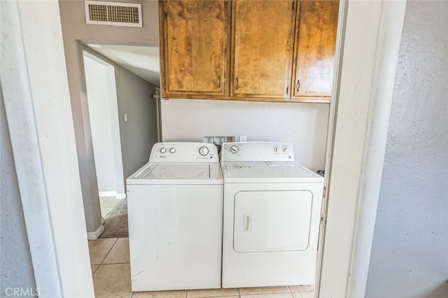 15917 Lee St, Mojave, CA 93501 - laundry area with washing machine and dryer, cabinet space, and light tile patterned flooring