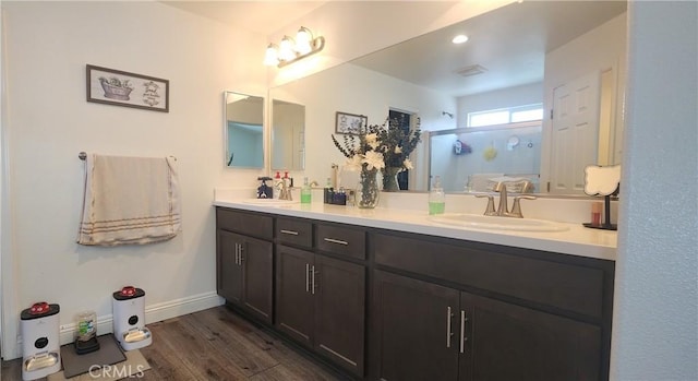 315 Fuente Dr, Guadalupe, CA 93434 - bathroom featuring double vanity, wood finished floors, and a stall shower