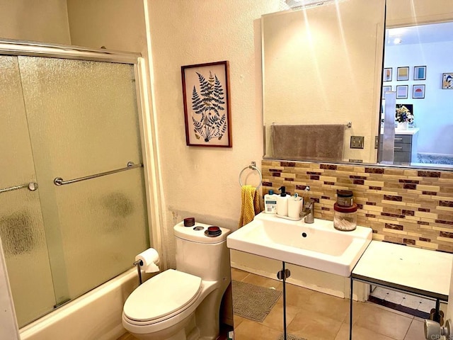 3029 Broadway Unit 22, San Diego, CA 92102 - full bathroom with tasteful backsplash, tile patterned flooring, shower / bath combination with glass door, and a textured wall