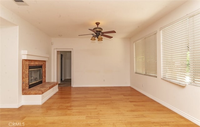 26508 Veramonte Ave, Murrieta, CA 92562 - unfurnished living room with a ceiling fan, a fireplace, and light wood-type flooring