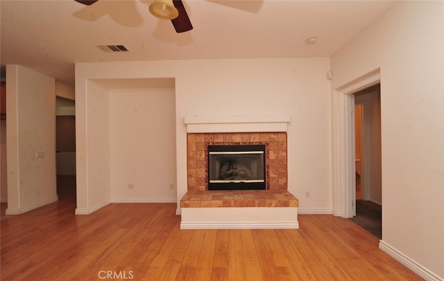26508 Veramonte Ave, Murrieta, CA 92562 - unfurnished living room featuring a ceiling fan, light wood-style flooring, and a fireplace