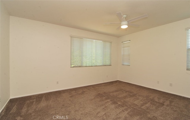 26508 Veramonte Ave, Murrieta, CA 92562 - spare room with dark colored carpet, ceiling fan, and healthy amount of natural light