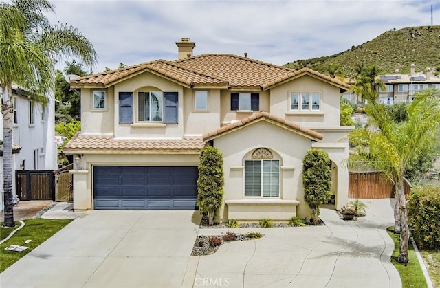 26508 Veramonte Ave, Murrieta, CA 92562 - view of front facade featuring driveway, an attached garage, stucco siding, and a mountain view