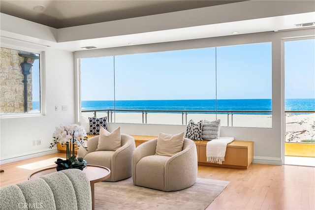 1554 E Oceanfront, Newport Beach, CA 92661 - living room featuring view of water and beach and wood finished floors