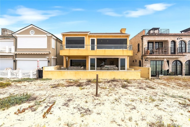 1554 E Oceanfront, Newport Beach, CA 92661 - back of house featuring a fenced front yard and a balcony