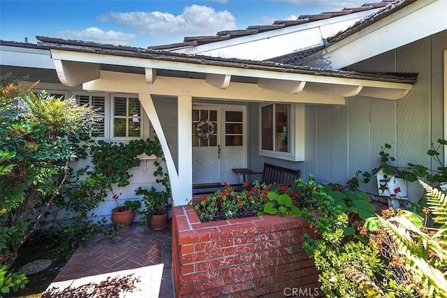 5591 Kenwood Ave, Buena Park, CA 90621 - doorway to property featuring board and batten siding and covered porch