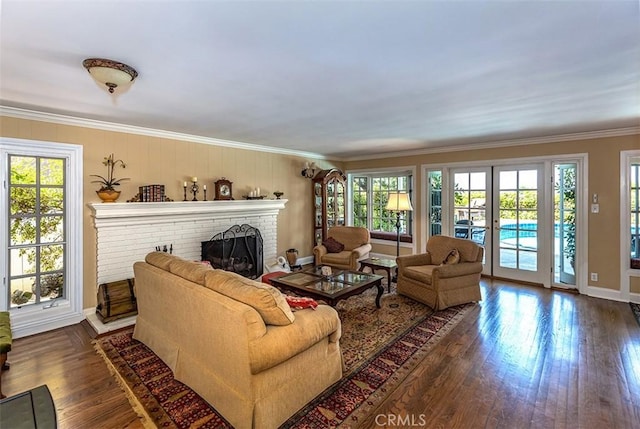 5591 Kenwood Ave, Buena Park, CA 90621 - living room featuring ornamental molding, a fireplace, dark wood-type flooring, and french doors