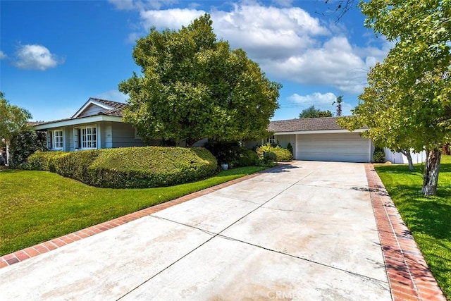5591 Kenwood Ave, Buena Park, CA 90621 - view of front facade featuring a front lawn, an attached garage, and driveway