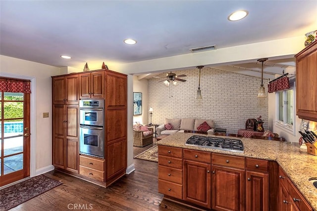 5591 Kenwood Ave, Buena Park, CA 90621 - kitchen featuring appliances with stainless steel finishes, brick wall, a peninsula, open floor plan, and dark wood-type flooring