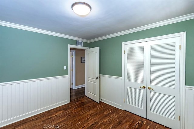 5591 Kenwood Ave, Buena Park, CA 90621 - unfurnished bedroom featuring dark wood-style flooring, wainscoting, a closet, and ornamental molding
