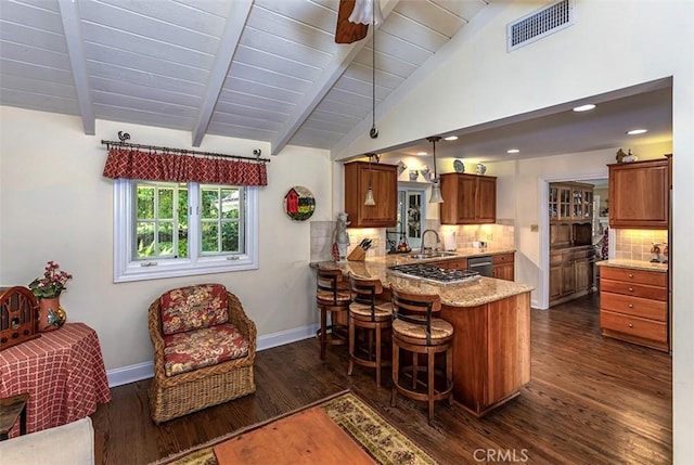5591 Kenwood Ave, Buena Park, CA 90621 - kitchen featuring brown cabinets, a peninsula, dark wood-type flooring, dishwasher, and a breakfast bar area