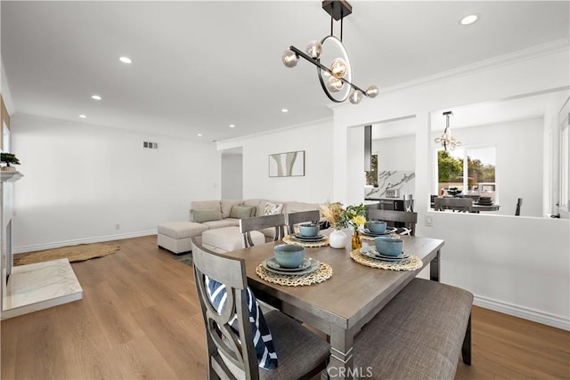 5001 N Darfield Ave, Covina, CA 91724 - dining room with a chandelier, crown molding, recessed lighting, and light wood-style flooring