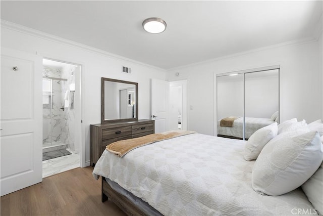 5001 N Darfield Ave, Covina, CA 91724 - bedroom featuring wood finished floors, a closet, crown molding, and ensuite bath
