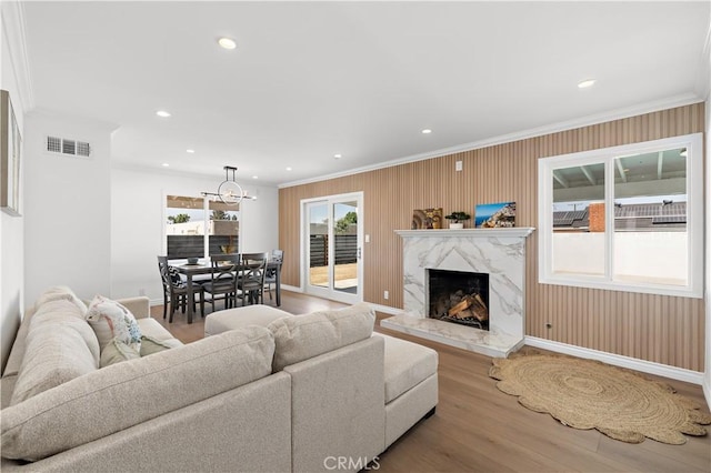 5001 N Darfield Ave, Covina, CA 91724 - living area with ornamental molding, wood finished floors, a fireplace, a chandelier, and recessed lighting