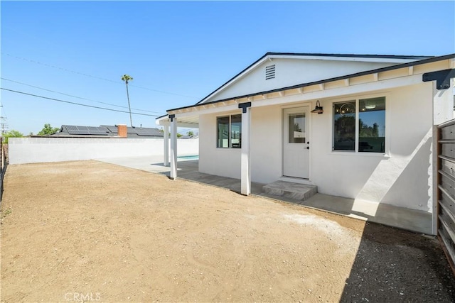 5001 N Darfield Ave, Covina, CA 91724 - rear view of property with stucco siding and a fenced backyard