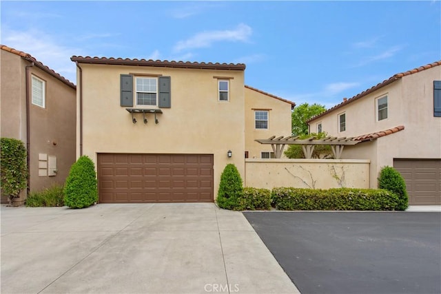 29 Windchime, Irvine, CA 92603 - mediterranean / spanish house featuring an attached garage, concrete driveway, stucco siding, and a tiled roof