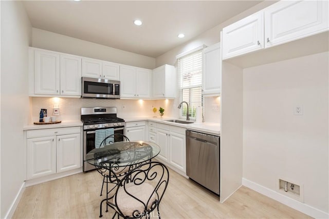 29 Windchime, Irvine, CA 92603 - kitchen with stainless steel appliances, light wood-style flooring, backsplash, light countertops, and recessed lighting